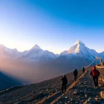 Trekkers on the Everest Base Camp Trek surrounded by stunning Himalayan peaks, showcasing the adventure and beauty of the journey.