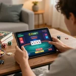 KUBET player strategizing during an online poker game on a tablet in a cozy home setting.