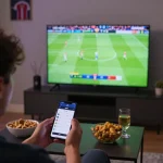Engaging in live sports betting with Nowgoal app while watching a football match on TV