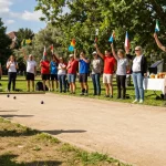 Action at a petanque tournament showcasing fopikotapalu.org with athletes competing in a vibrant park.