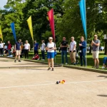 Petanque enthusiasts engaging in a friendly competition at fopikotatarakan.org, showcasing teamwork and community spirit.