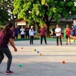 Petanque players in action at FOPI Kota Banjarbaru, showcasing vibrant sportsmanship.