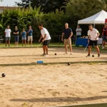 Engaging petanque game at fopikotatomohon.org featuring players and supporters.